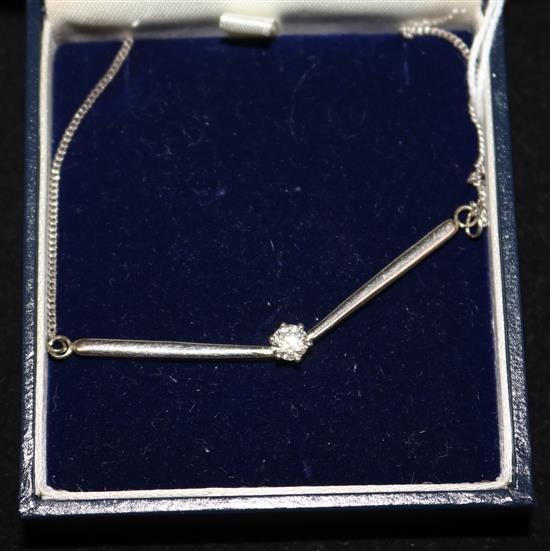 A modern 18ct white gold and solitaire diamond pendant necklace, approx. 14in.